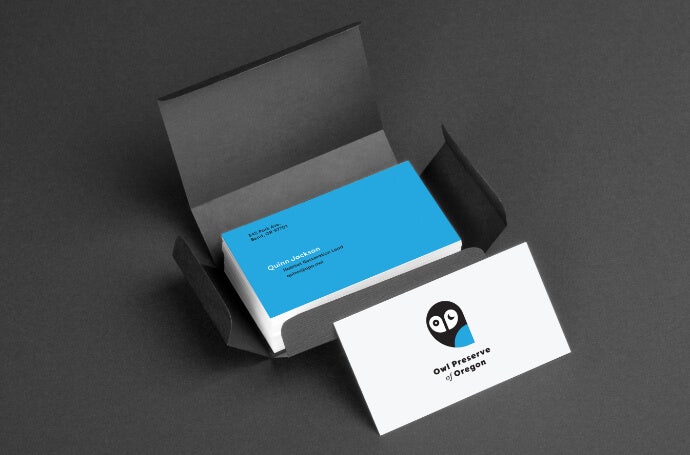 Business cards with owl logo in an opened package