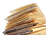 photo of a stack of paper and file folders