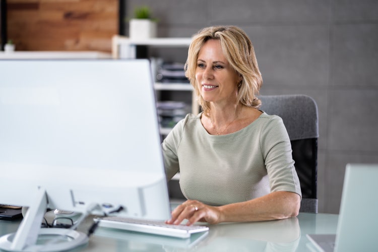 Woman learns how to create a performance review template on her computer.