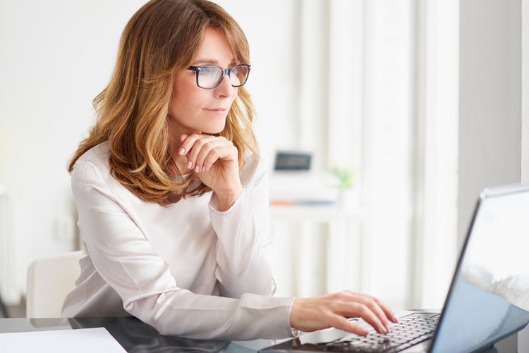 A woman uses her laptop to get started on an RFI procurement project.