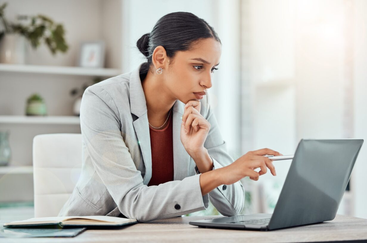 A woman shows how to streamline your document approval workflow with Adobe Acrobat on her laptop.