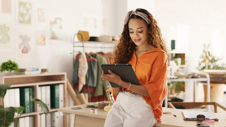 A woman uses a table to learn about the most common types of business licenses