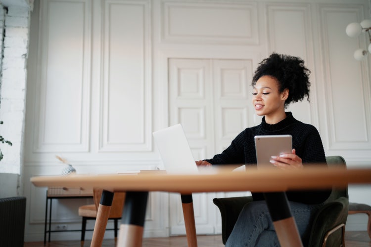 A woman reviews a request for proposal for services for her business.