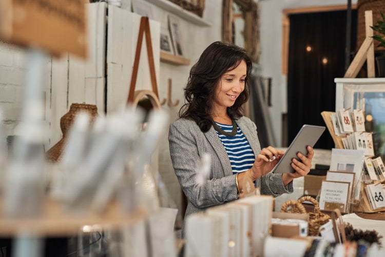 A woman uses work order software on her tablet.