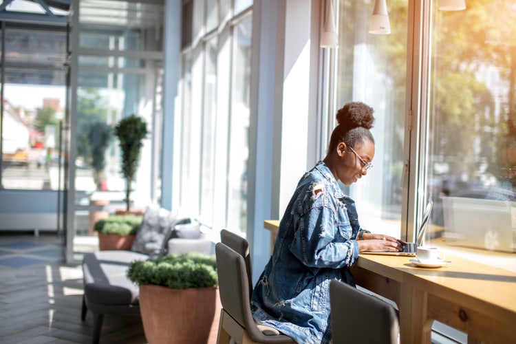 A person reviewing a letter of interest on a laptop at a desk