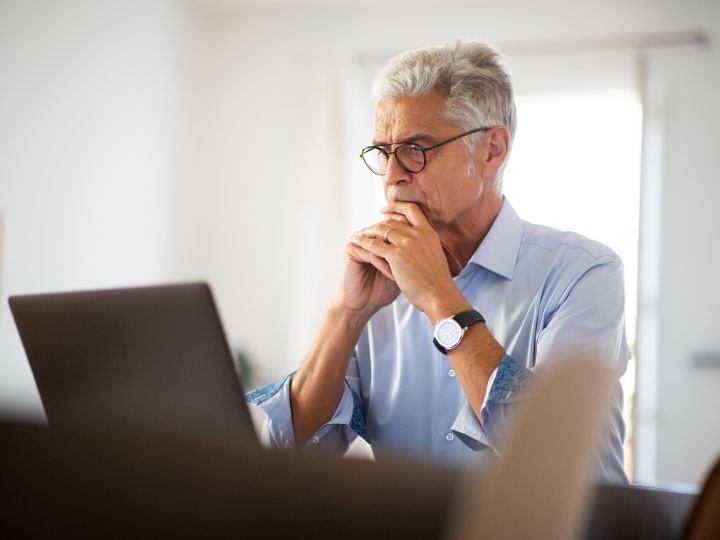 A photo of a person looking at an advance directive on a laptop computer.