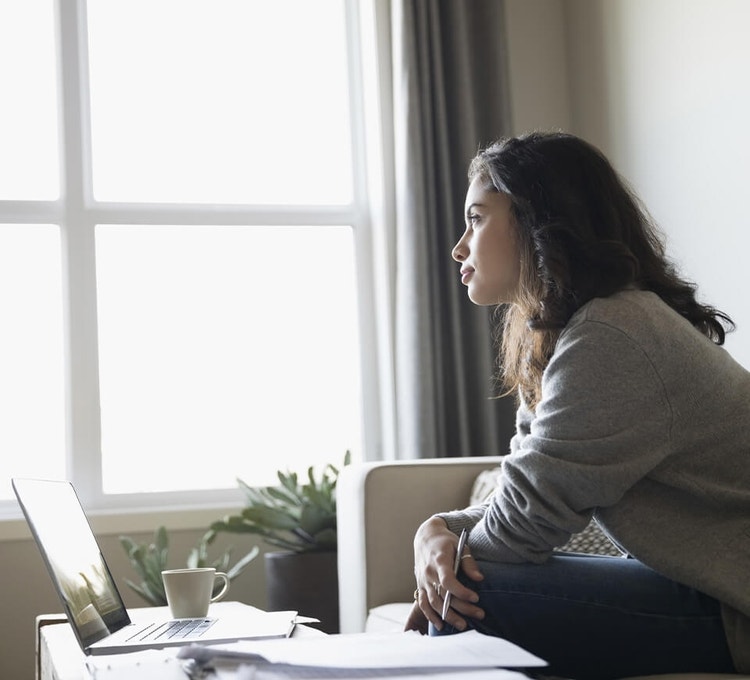 A landlord working on a termination letter on their laptop