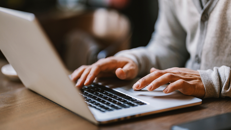 Person uses laptop to redact a PDF.