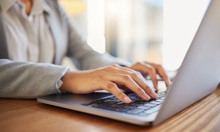 A woman saves certain pages of a PDF on her laptop.