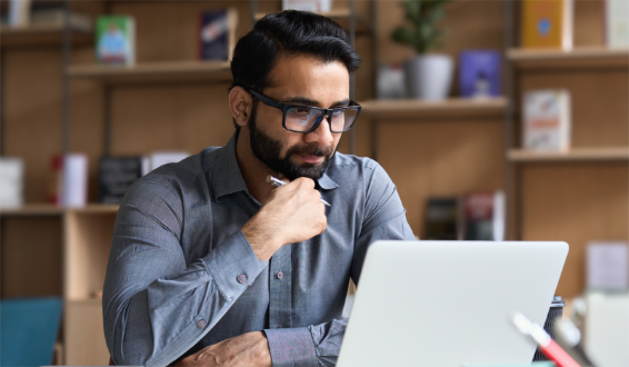 A man translates a document on his computer to a different language.