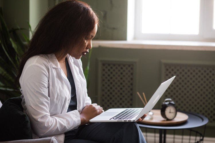 A woman combines images into PDF files on her laptop.