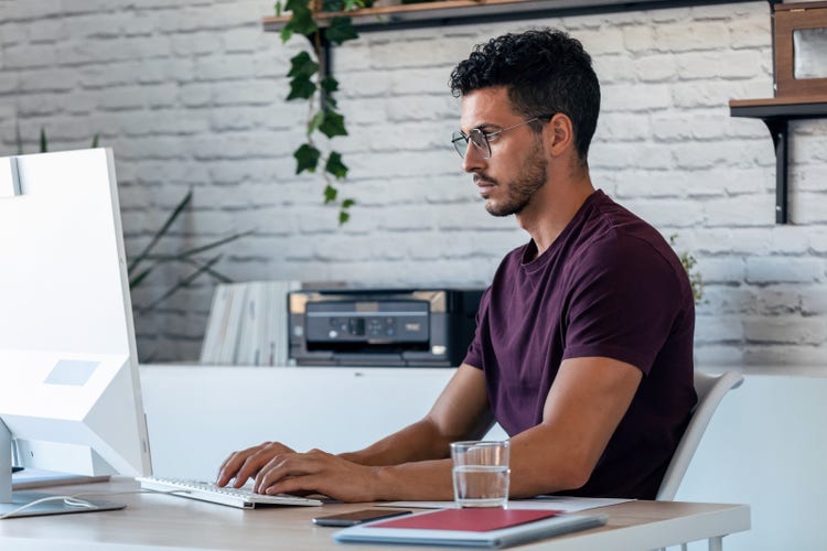 A man merges PDF documents on a PC.