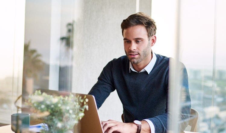 A man reads a PDF on a Chromebook.
