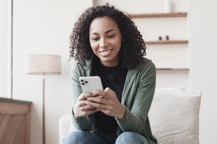 A woman converts a picture to a PDF on her iPhone.