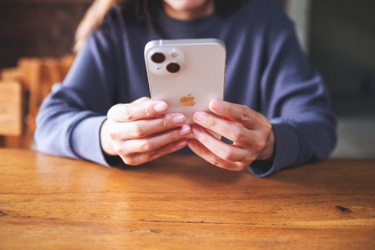 A woman downloads a PDF file to her iPhone.