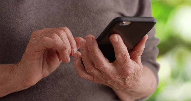 An iPhone in hand being used to type on a PDF.