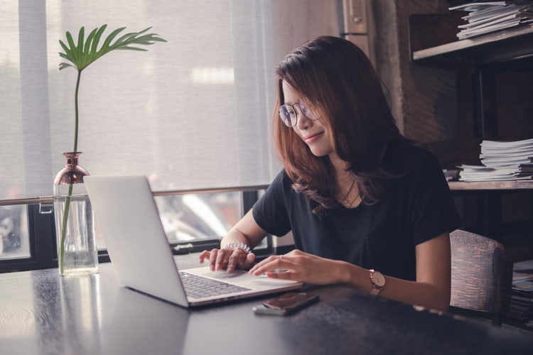 A woman uses her laptop to stay productive while working offline.