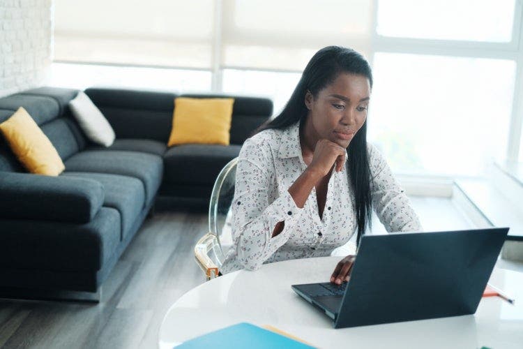 A woman marks up a PDF file using a PC laptop.