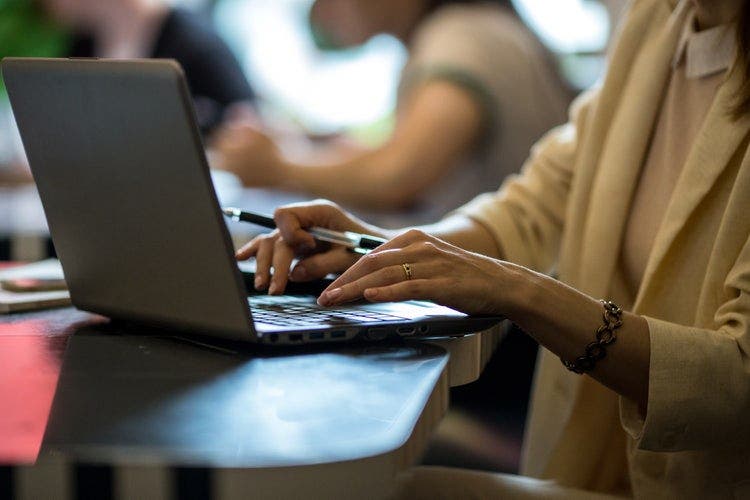 A woman in an office redacts a PDF on Windows 10.