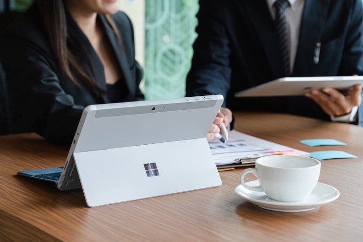 Business executives combine PDFs on Windows 10.