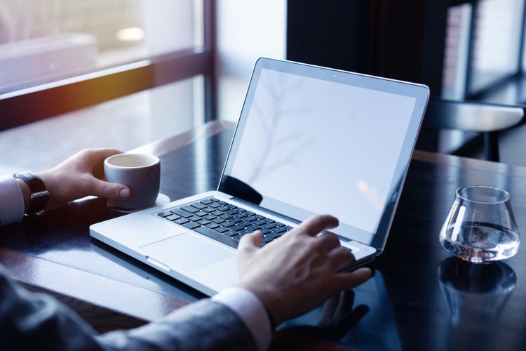 A person uses a Mac laptop to fill out a PDF form.