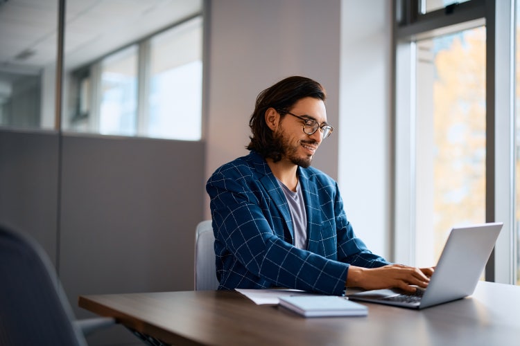 A man learns how to electronically sign a Word document on his laptop.