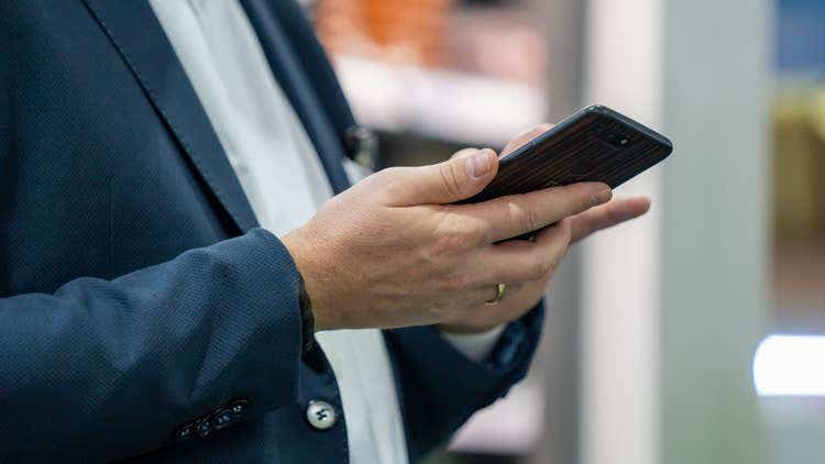 A man uses his android phone to delete PDF pages.