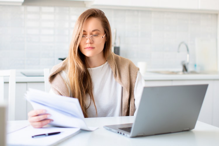 A woman completing the IRS 8822 form on her laptop computer.