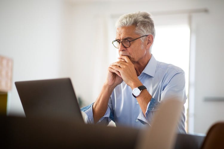 A photo of a person looking at an advance directive on a laptop computer.