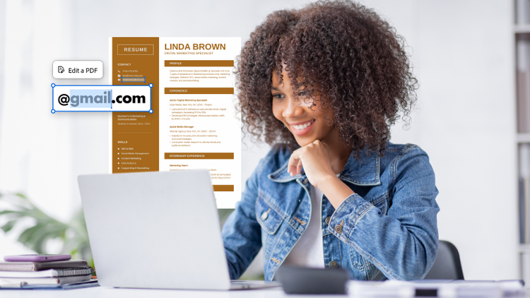 A woman sitting at a computer editing a resume.
