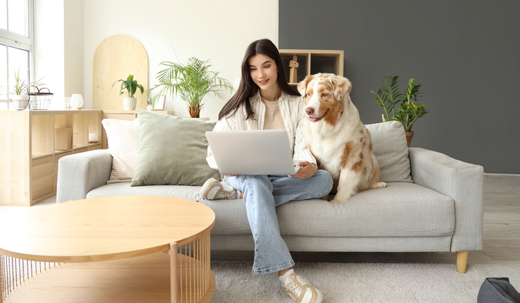 An image of a woman with a dog using a laptop to search a PDF document.