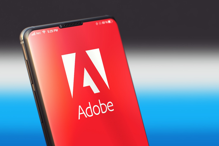 Photo of smartphone with Adobe logo on the screen.