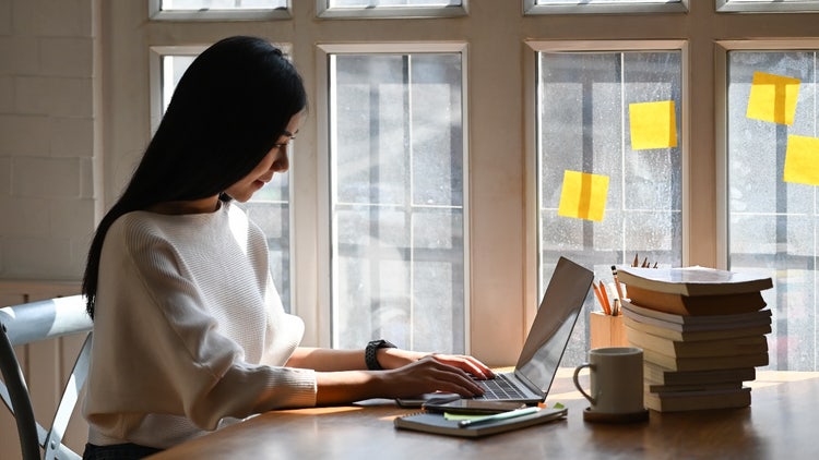 A person working on the computer at a desk