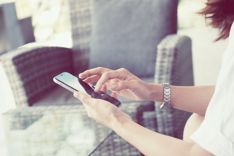 Young professional typing on iPhone