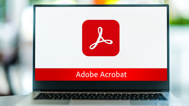 Laptop computer displaying on screen the Adobe Acrobat logo.