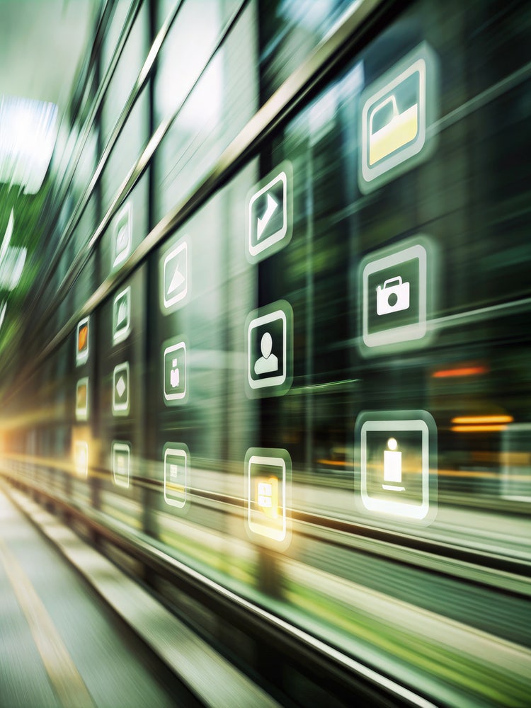 Image showing digital download icons projected onto a modern glass building exterior.