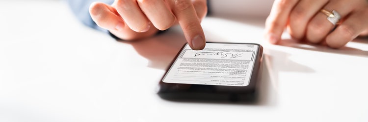 A person is signing a digital signature on mobile.