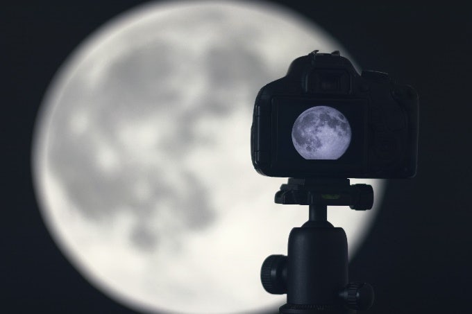 Camera with full moon in focus