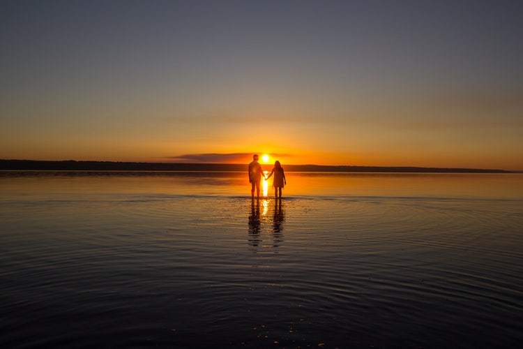 Sunset at beach with horizon exactly in middle.