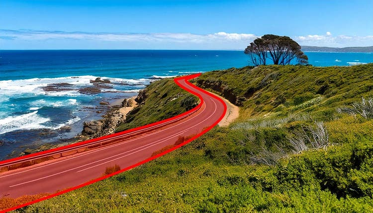 Great Ocean Road winding along coastline in S-curve.