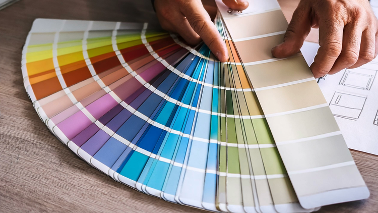 Close up of hands examining various color palette strips