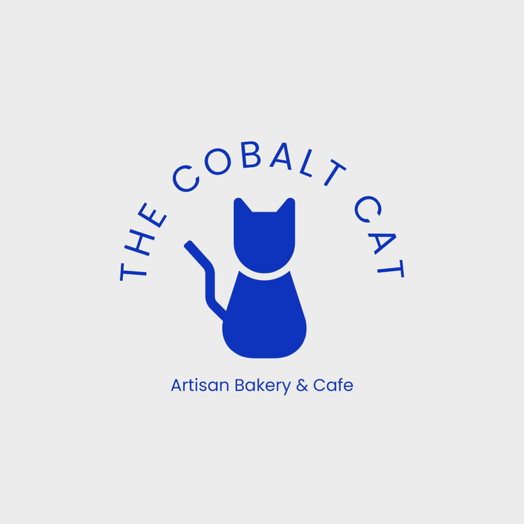 The Cobalt Cat Artisan Bakery & Cafe logo written in the font Poppins in blue with an icon of a cat
