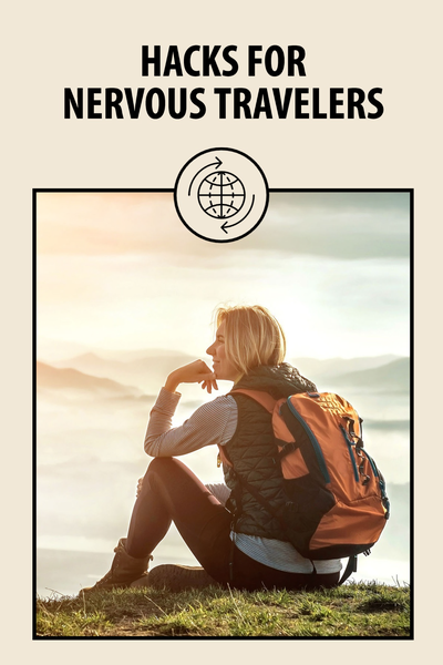 "Hacks for Nervous Travelers" blog post with an image of a person sitting in front of a vista wearing a backpack