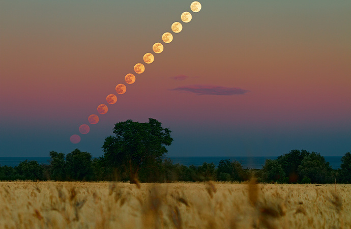 Time-lapse astronomy photo of the moon travelling across the sky.