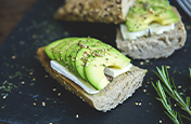 Mouth-watering image of an open-faced avocado and cream cheese sandwich