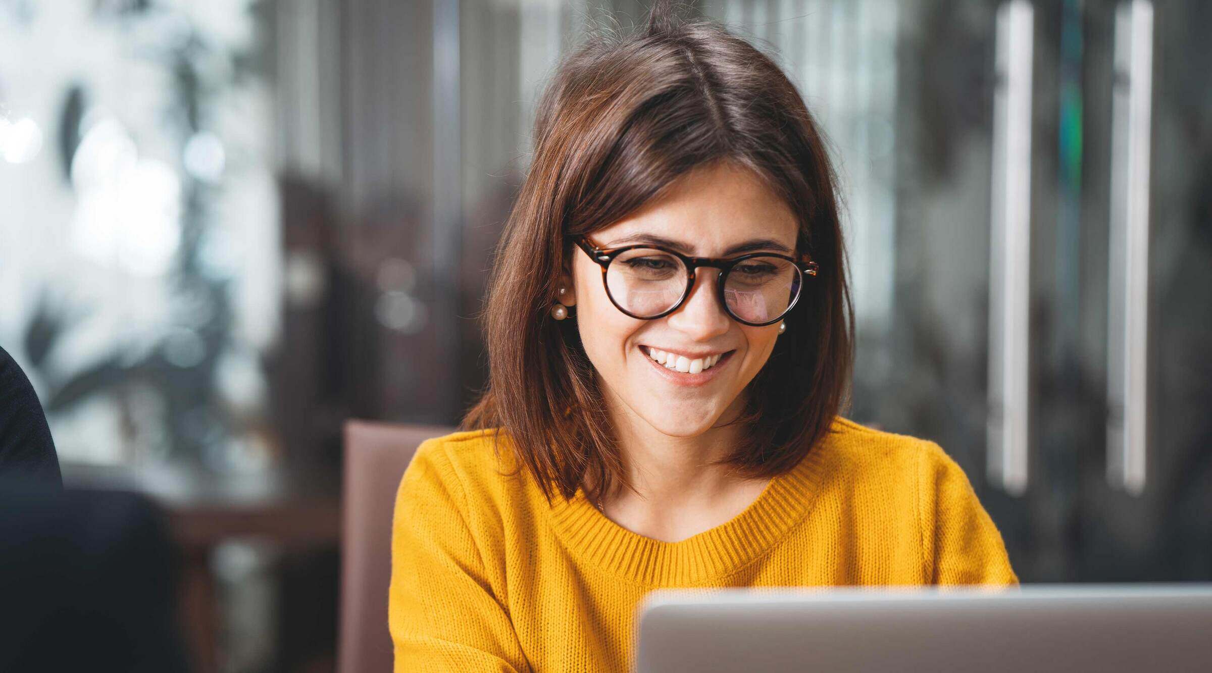 A person sitting at a desk looking at their computer