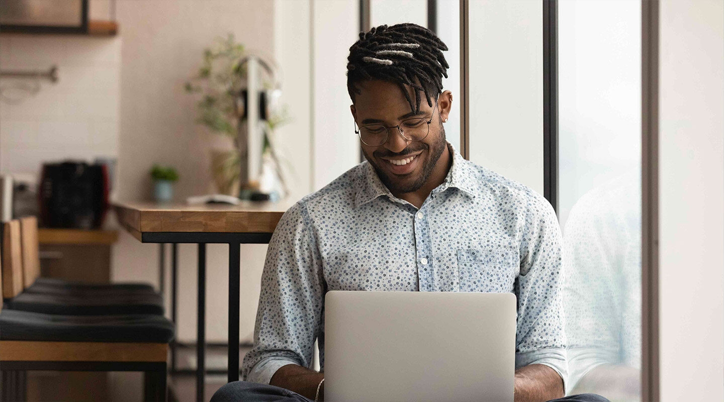 A person sitting at a desk looking at their computer