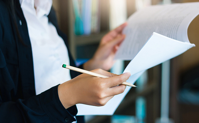 Businesswoman checking important papers.