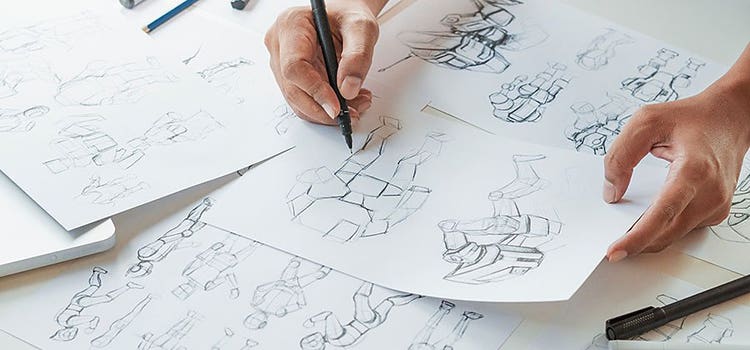 Person sketching animated characters onto paper.