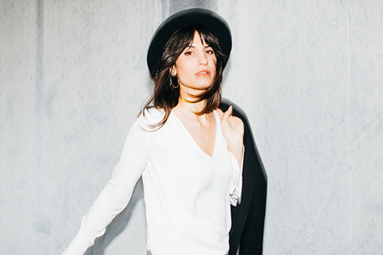 A model posing in front of a cement wall that bounces the light from an LED flash in poor lighting conditions